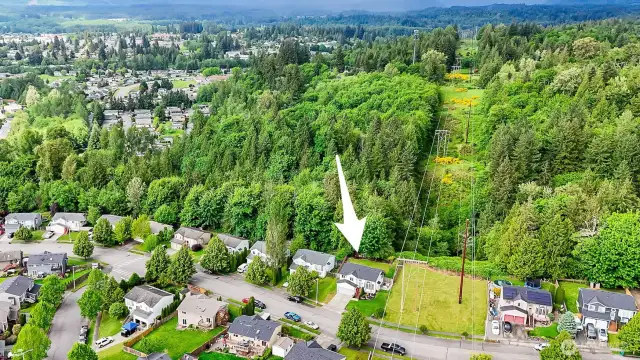 Aerial view shows the home’s location backing to greenbelt and utility corridor—privacy and space with no rear neighbors.