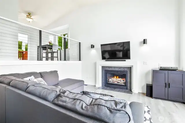 Vaulted ceilings, gas fireplace and large arched windows fill the living area with natural light. Great room layout ideal for relaxing or entertaining.