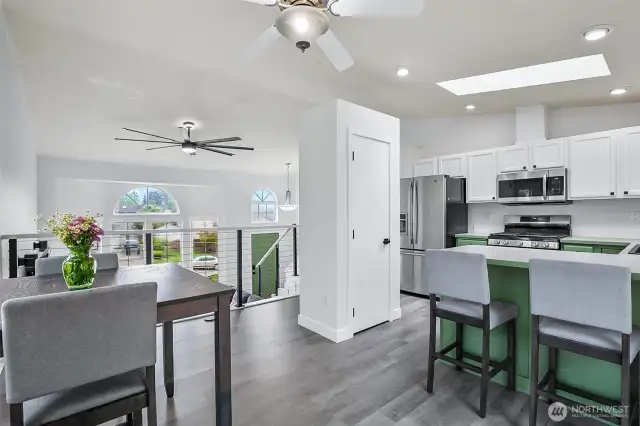 Open-concept layout connects kitchen and dining to vaulted living space below. Great for entertaining and everyday living.