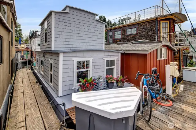 Dock side with deck space, storage, and a bicycle rack.