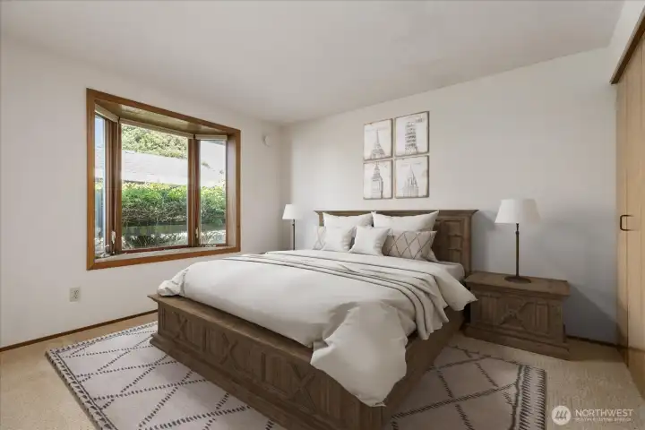 Main floor primary suite virtually staged