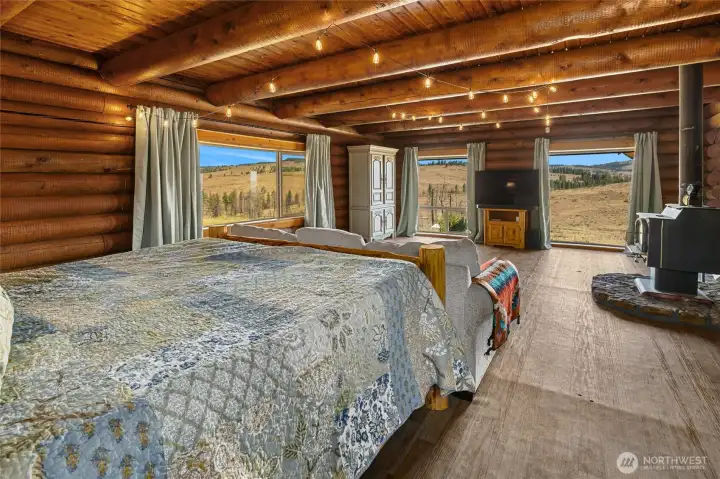 Ginormous bedroom downstairs with cozy stove.