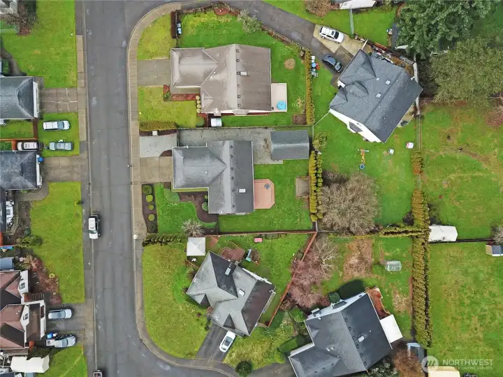 Aerial view showcasing the generous lot, large backyard, and detached shop/garage — nicely positioned on a quiet Covington street with plenty of space to spread out.