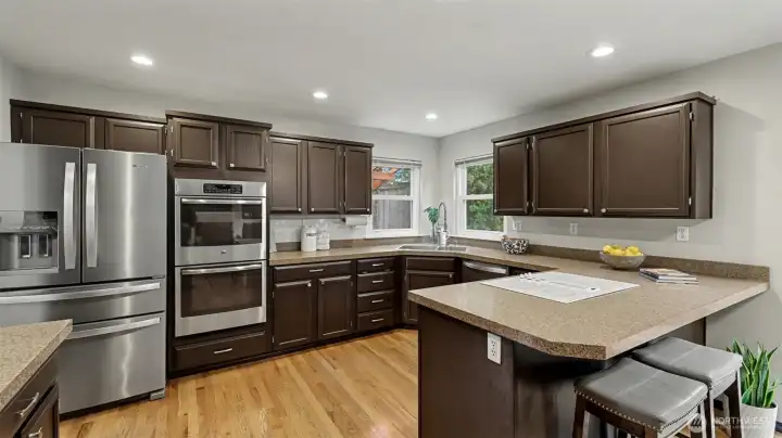 Rich espresso cabinetry lends refinement to the spacious kitchen