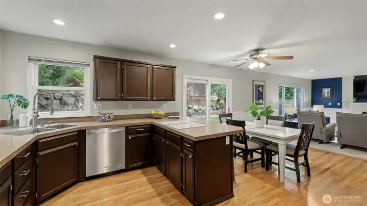 Recessed lighting and large windows with backyard views provide a light filled space.