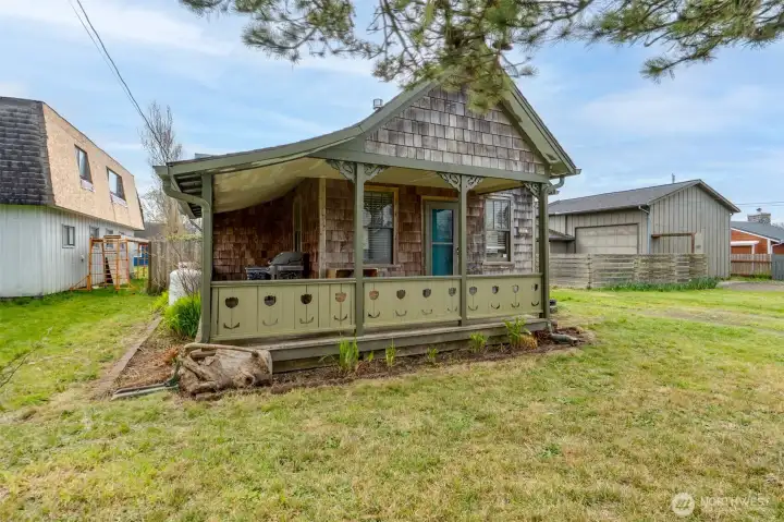 covered front porch protects you from the elements. Shingle siding adds coastal charm.