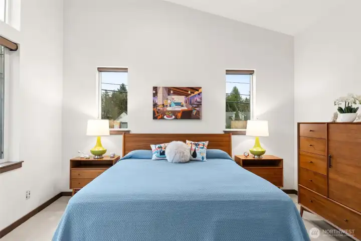 Light-filled, spacious primary bedroom with vaulted ceilings, a walk-in closet, and an attached ensuite bath.