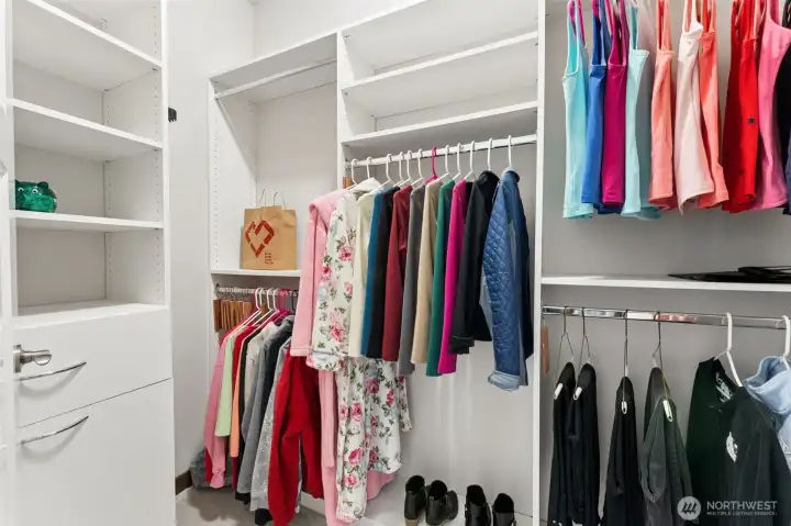 Generous walk-in closet complete with an organized storage system.