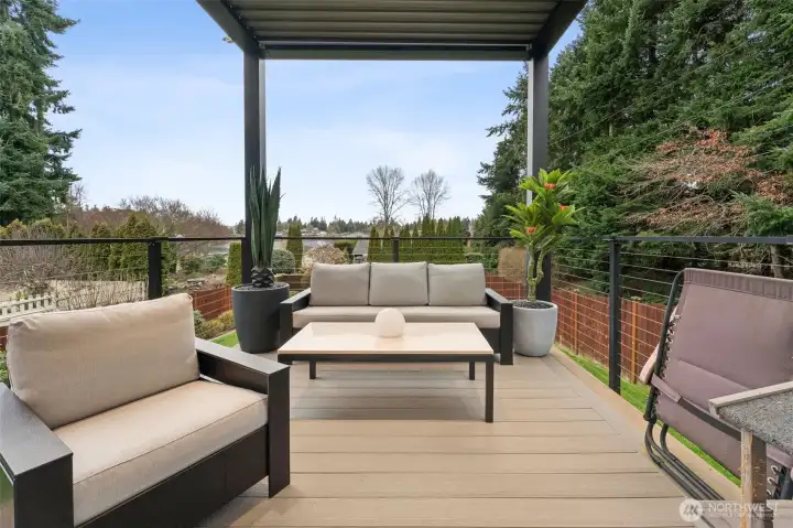 Lower deck w/ motorized deck cover and integrated lighting create a warm, inviting outdoor ambiance overlooking the lake.