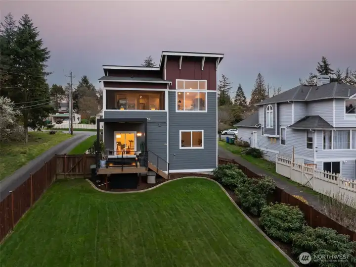 Gorgeous angle lake view home w/ covered outdoor entertaining space.