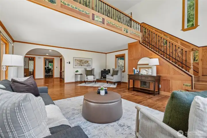 Another view of Living Room with propane fireplace and stairs to Massive primary Bedroom.