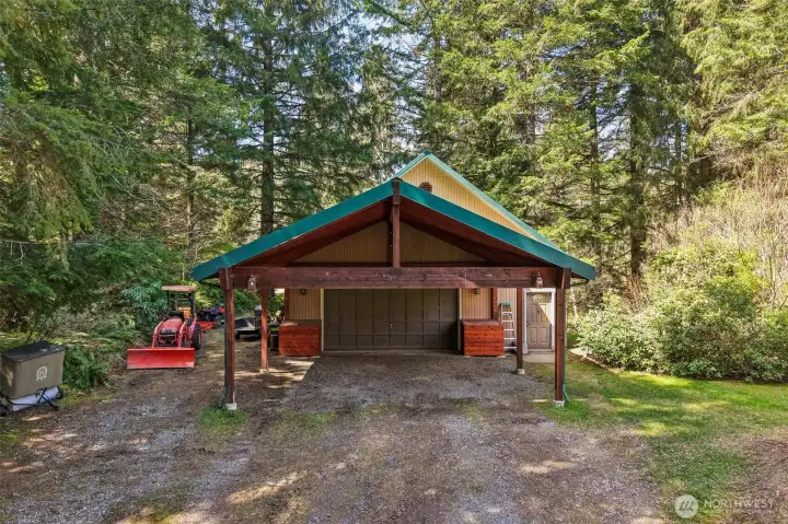 Over-sized 2 car Garage, shop upstairs and carport, Storage galore.