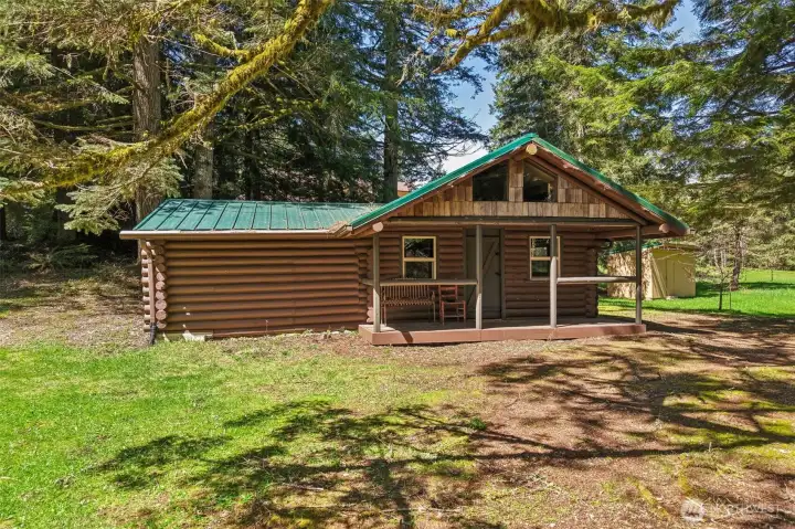 Refurbished Cabin (Accessory Unit) and well house in background, with large pond on your right.