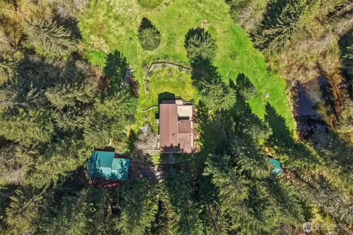 Drone view of property, with Garage, House and Cabin.