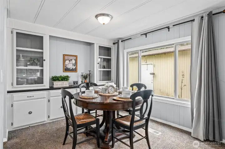 Beautiful built-in storage hutch and glass paned upper cabinets.