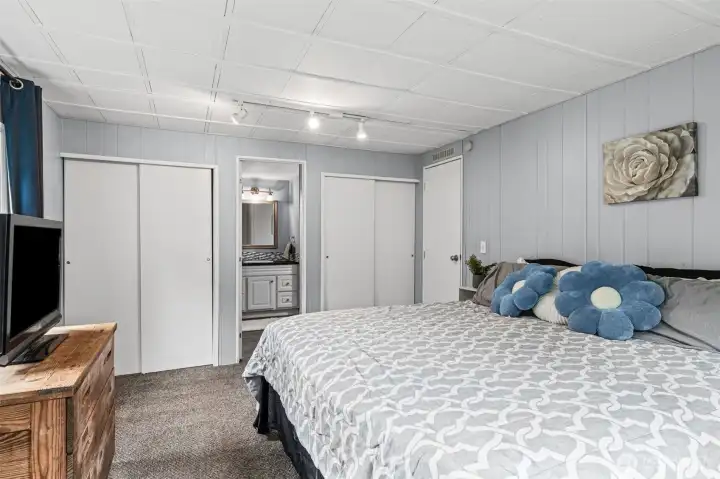 The primary bedroom with two closets and en-suite bathroom.