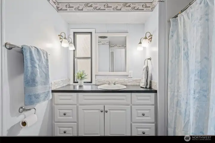 Guest bathroom with tub/shower combo.