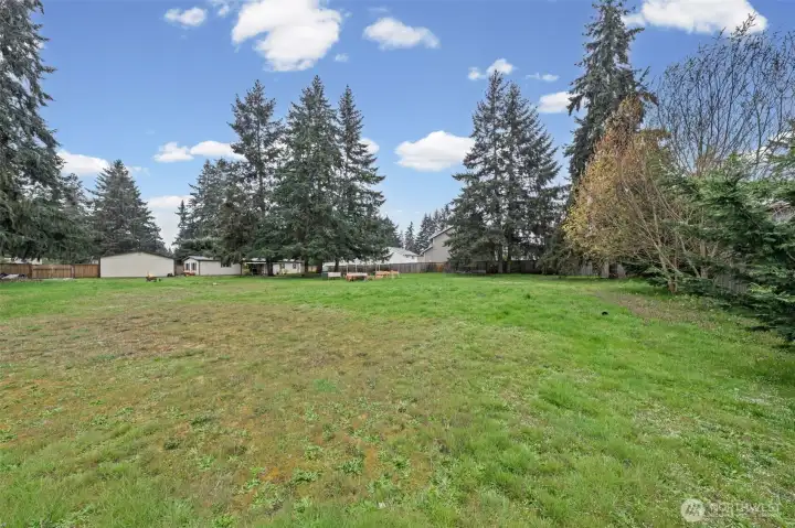 View of the backyard looking towards the home and detached shop.