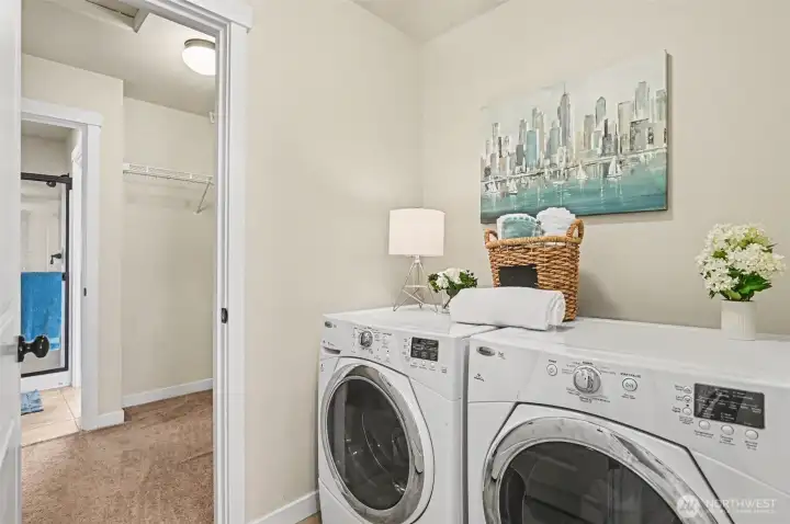 The laundry room is conveniently located upstairs with a door from the primary suite closet into the laundry area.