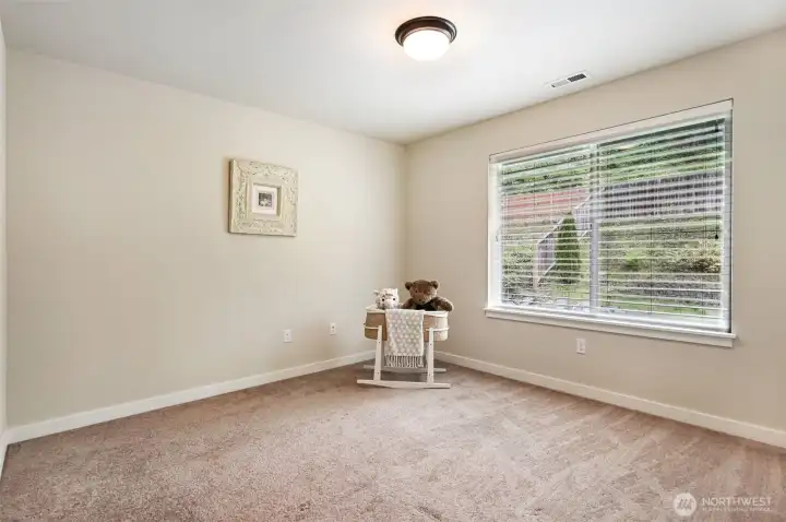 One of four spacious bedrooms with a greenbelt view.