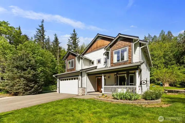 Exterior view highlighting the landscaped front yard, extended driveway, and secluded King County setting on a dead-end street.