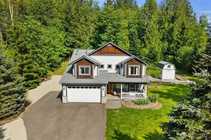 Peaceful Pacific Northwest acreage property surrounded by mature trees and natural beauty. The long driveway, spacious lot, and private setting offer the kind of space and privacy many buyers are searching for in Washington State.