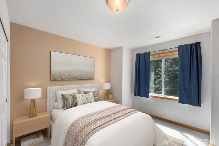 Bright and inviting bedroom with soft natural light, neutral finishes, and peaceful wooded views. The warm tones and clean layout make the space feel calm, comfortable, and easy to imagine as a guest room, office, or everyday bedroom.
