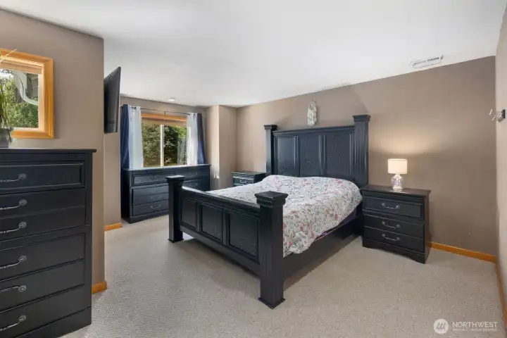 Private primary suite with oversized layout, large windows, and peaceful views of the surrounding greenery.