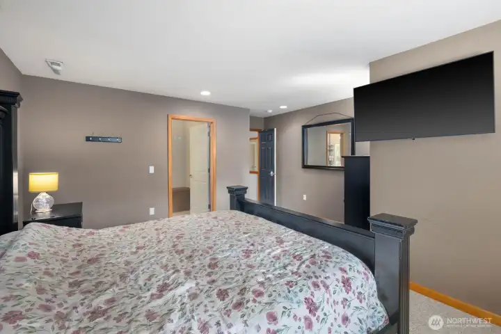 Spacious primary suite with oversized footprint, neutral finishes, and flexible layout for comfort and functionality.