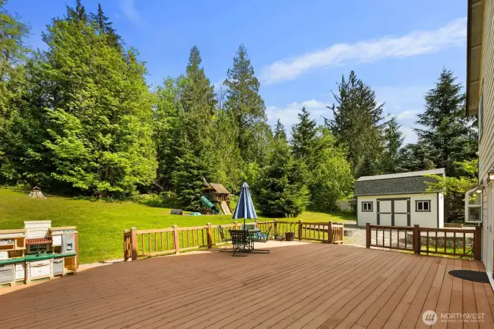 Large entertaining deck overlooking the backyard, offering plenty of room for outdoor dining, gatherings, and relaxing.