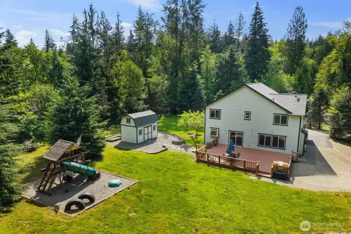 Expansive back deck with room for outdoor dining, entertaining, and relaxing while overlooking the large yard. The property offers a rare combination of usable outdoor space, privacy, and wooded surroundings.