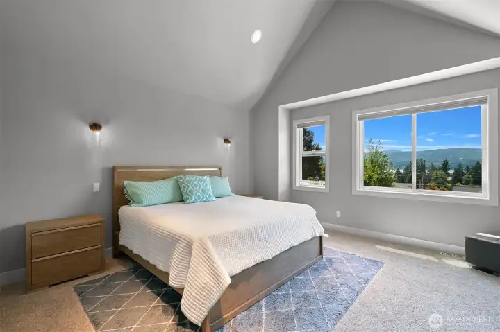 The primary bedroom has views out to the lake