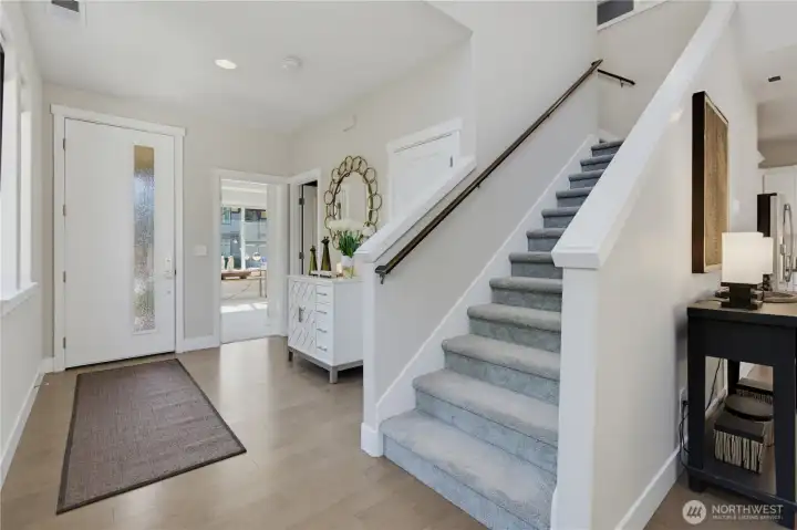 We can see the front door, office/bedroom door, bath entry door then the hallway furnishing and on the far right a big hall closet and stairs to up. We can see the front door, office/bedroom door, bath entry door then the hallway furnishing and on the far right a big hall closet and stairs to up.