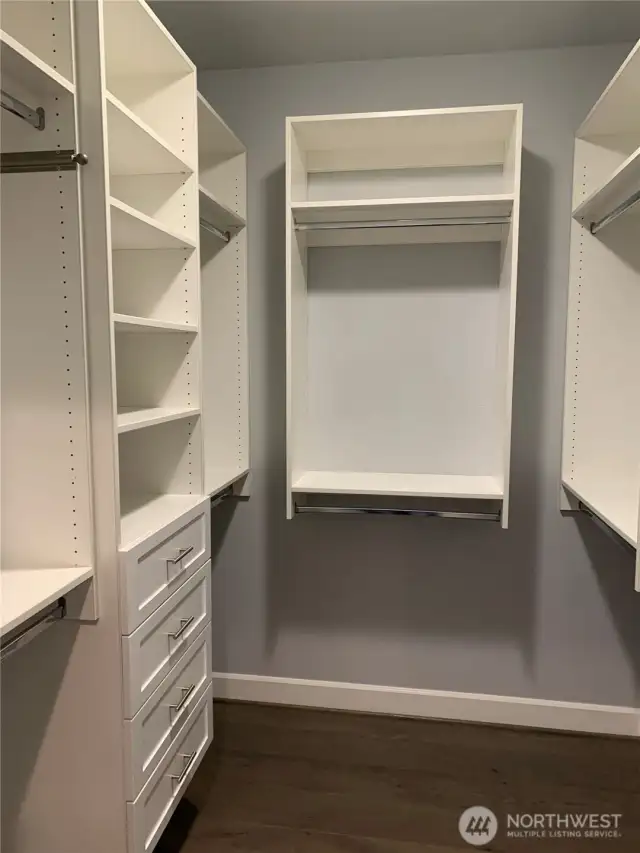 primary suite walk-in closet with custom shelving