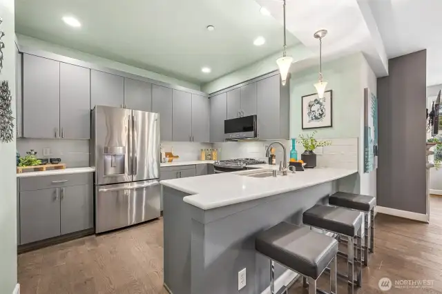 The open kitchen with breakfast bar has been tastefully remodeled.