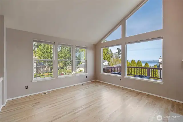 Soaring windows & skylights flood home with natural light.