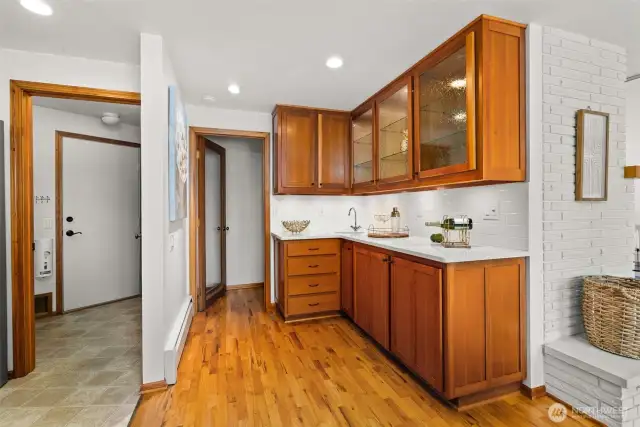 Wet bar with in cabinet and under cabinet lighting.