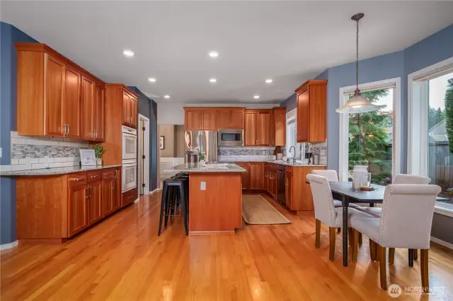 Gleaming hardwood floors add warmth and character throughout the kitchen and adjacent living spaces.