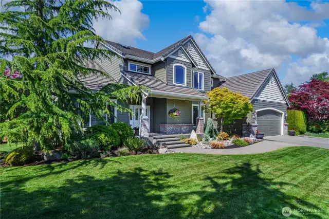 This home is perfectly situated on a corner lot and showcases incredible curb appeal—pride of ownership is evident at every turn.