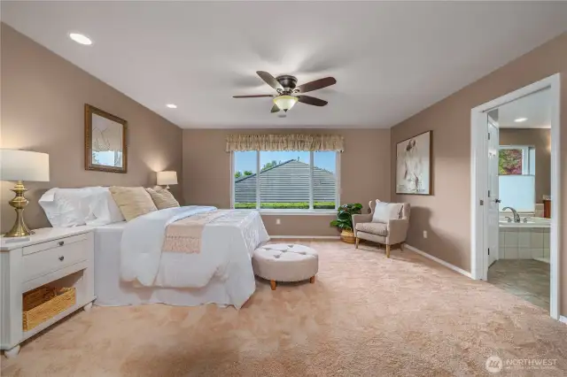 The spacious primary suite is a relaxing retreat and easily accommodates larger furniture.