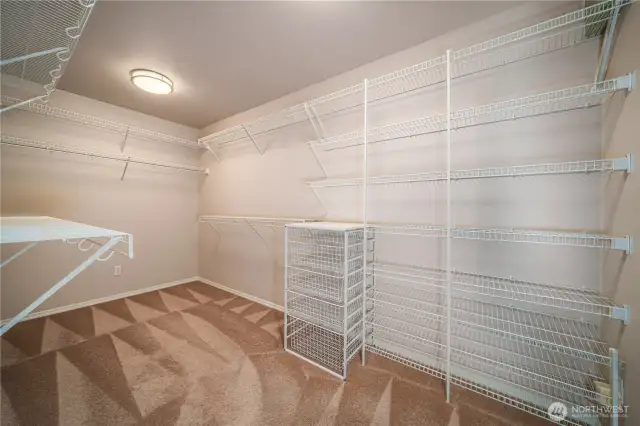 The large walk-in closet is outfitted with organizers to make the most of every inch of space.