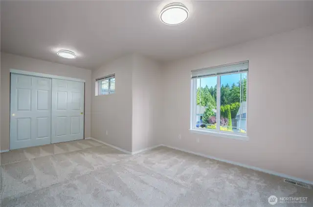 The third bedroom upstairs feels spacious, with a large closet and a sunny picture window.