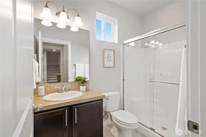 Main floor bath/powder room just off the kitchen/dining area & main floor bedroom