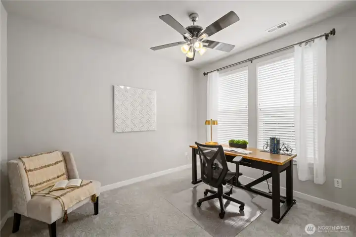 Main floor bedroom 4 doubles as an office space