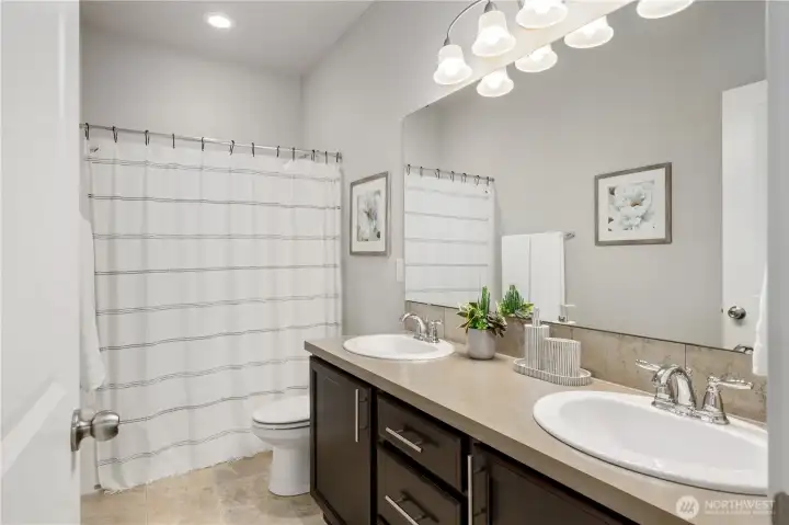 The upstairs hall bath serves the two additional bedrooms
