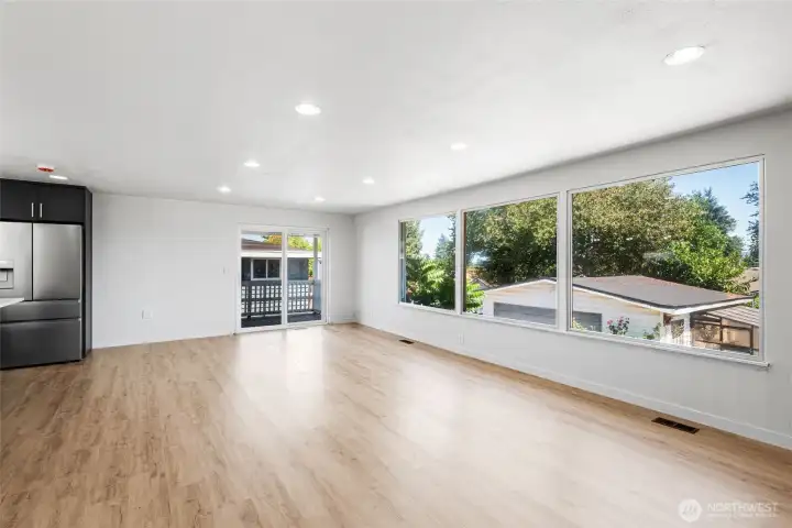 Huge picture windows brings tons of natural light to this bright and open living area