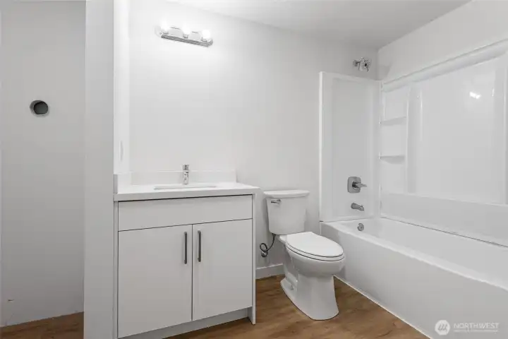 Main level, full bath with new vanity, toilet, tub and surround, ready for you to finish it to make it yours.