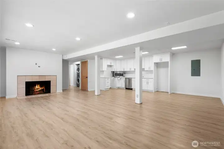 Enter downstairs to find an open living area with a wood burning fireplace and kitchenette.