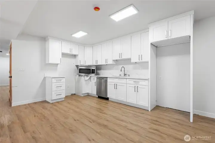 Kitchenette boasts new counters, cabinets and space for a refridgerator and stove.