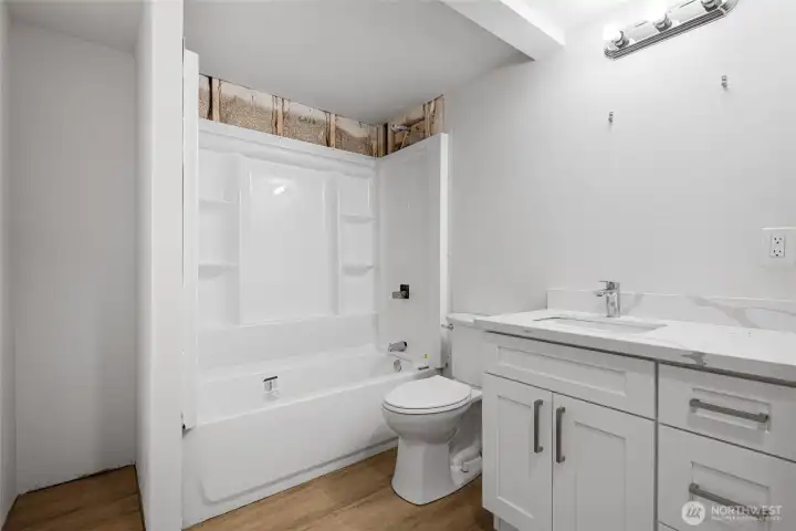 Basement full bath with new tub, shower surround and vanity, just waiting for your personal touches to complete it.